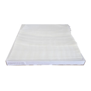 Stack of baking paper sheets on a white box.